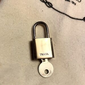 Authentic Prada lock and key silver hardware in fair condition. Some scratches